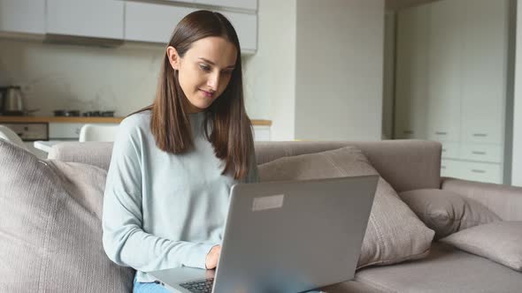 Freelance Woman Using Laptop for Remote Work From Home