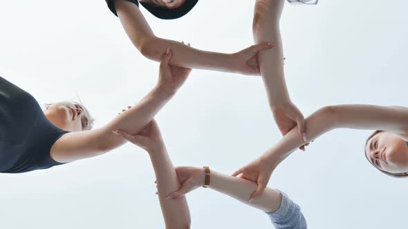 Friends Join Their Wrists and Make a Circle