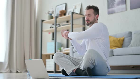 Man Teaching Yoga on Video Call While Sitting on Yoga Mat