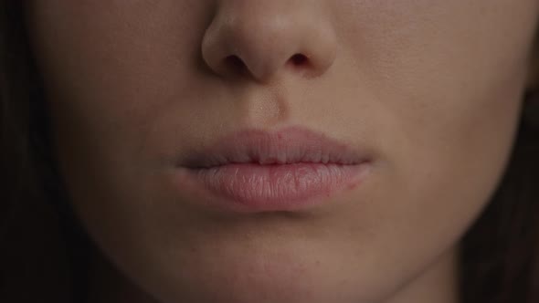 Close Up of a Caucasian Woman Lips Doing a Kiss and a Smile in Slow Motion