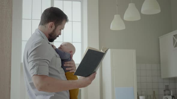 Dad Reading To Toddler Son