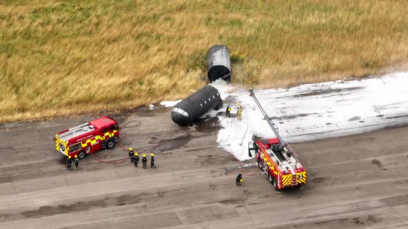 Firefighters Training to Tackle a Fire of a Dummy Aircraft