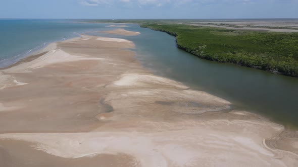 Aerial drone shot of Buffalo creek Leading to ocean, with Sandy beach and Dense bushland near Lee Po