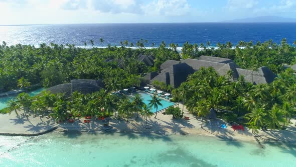 Aerial drone view of a luxury resort and pool in Bora Bora tropical island.