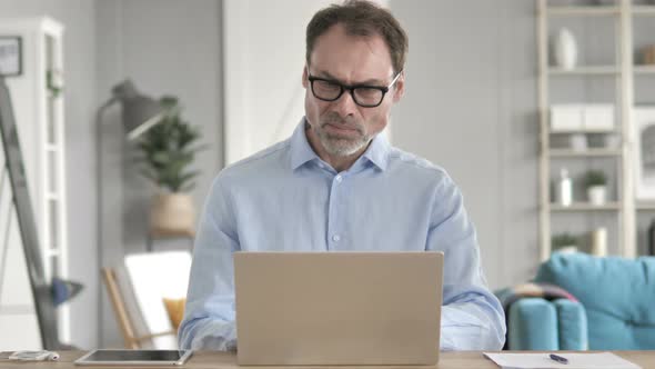 Senior Aged Businessman with Neck Pain at Work