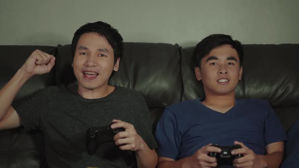 two man playing video games and wins