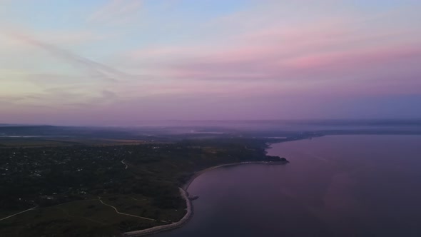 Aerial drone view of the Duruitoarea natural reservation at sunset in Moldova. River and village, hi