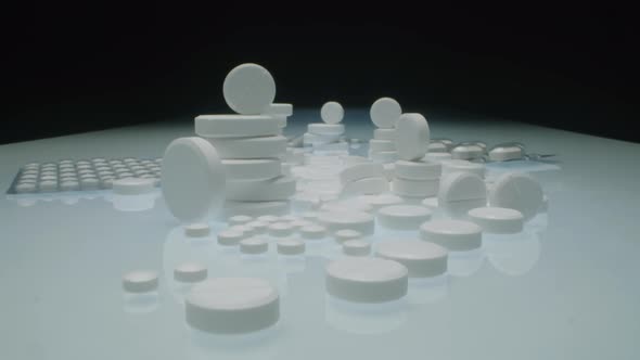 Stacks of White Tablets and Blister Packs with Pills on Table