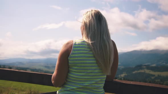 Woman Drinking Hot Beverage in Mountains