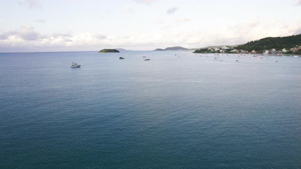 Many Yachts Sail Off the Coast at Sunset