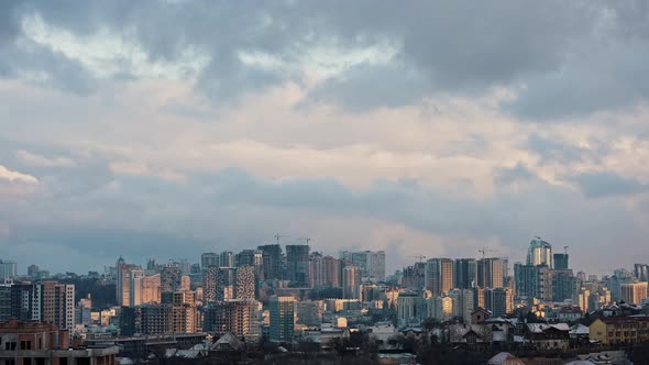 Time Lapse Shot of City with Sunlight and Clouds Floating in Sky Over Buildings