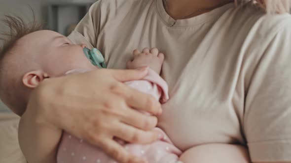 Baby Sleeping in Arms of Woman