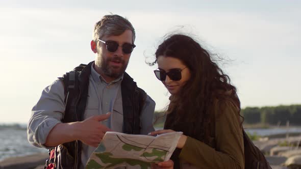 Tourist Couple Discussing Route on Map