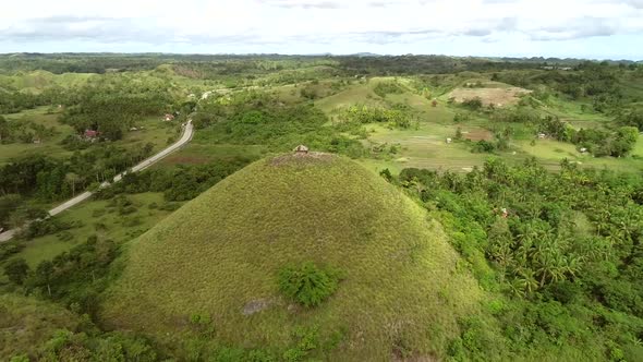 Aerial view of house on the top of Chocolate Hills Complex, Batuan, Philippines.