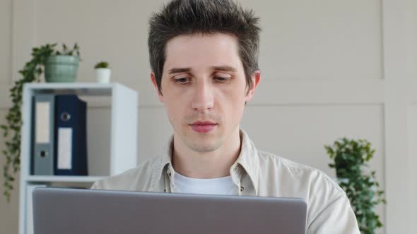 Focused Business Man Caucasian Millennial Entrepreneur Typing on Laptop in Office