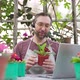 Man Sells Flowers and Seedlings Via Video Link on a Laptop Via the Internet - VideoHive Item for Sale