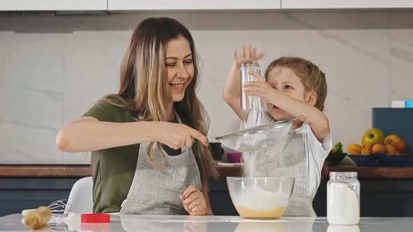 Sympathetic Mother and Daughter in Kitchen