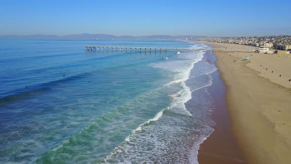 Aerial drone uav view of a pier over the beach and ocean.