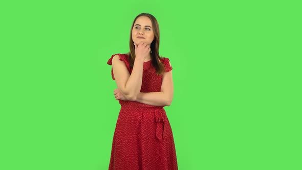 Tender Girl in Red Dress Is Daydreaming and Smiling Looking Up. Green Screen