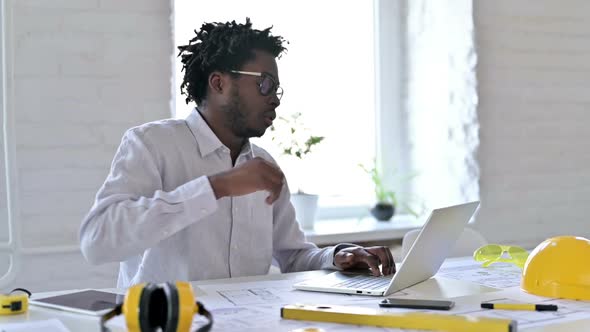 African Engineer Having Back Pain in Office