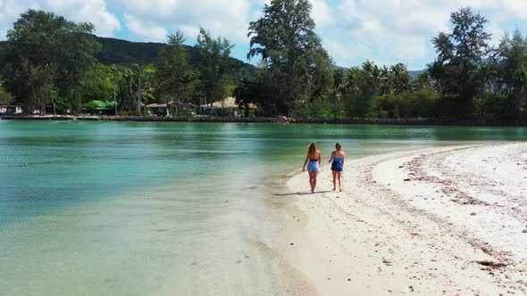 Beautiful ladies look beautiful on marine island beach adventure by blue sea and white sandy backgro