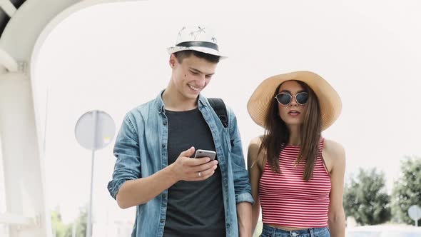 Couple Using Mobile Phone, Traveling On Summer Vacation