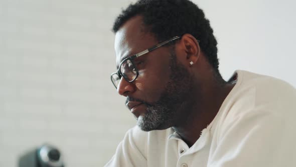 African man in eyeglasses at home