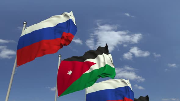 Flags of Jordan and Russia on Sky Background