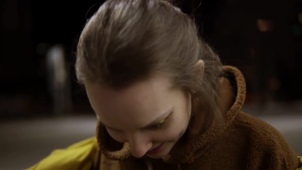 Young Expansive Woman Sensually Dancing Outside in Yellow Jacket