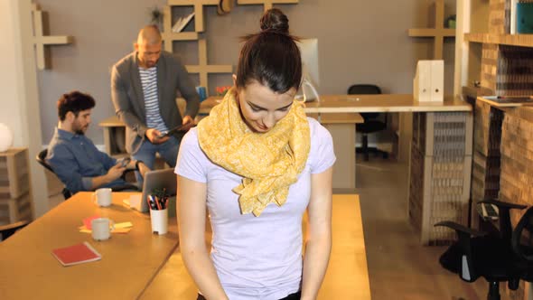 Portrait of female business executive smiling while coworker interacting in background