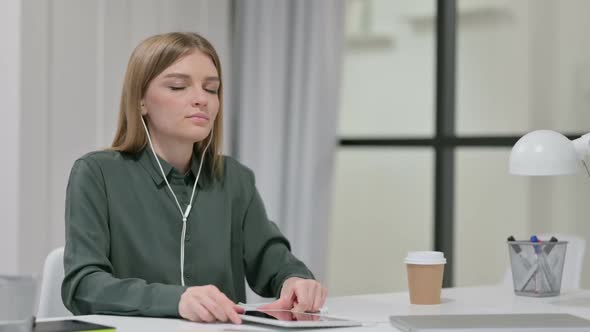 Young Woman Meditating with Music on Smartphone