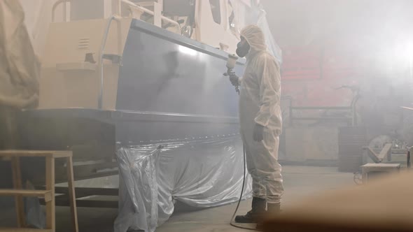 Person Spraying Boat with Airbrush