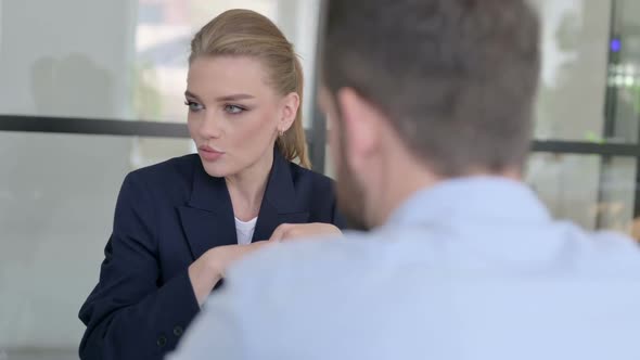 Beautiful Businesswoman Having Discussion with Mixed Race Businessmen in Office