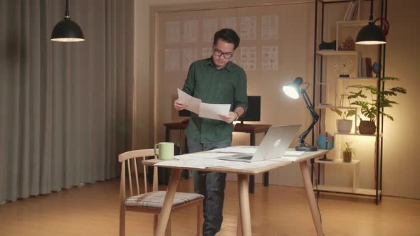 Creative Designer Uses On A Laptop Sitting At His Desk In The Modern Studio, Working On A Storyboard