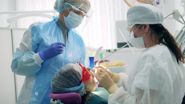 Dentists are Working on Patient's Oral Cavity