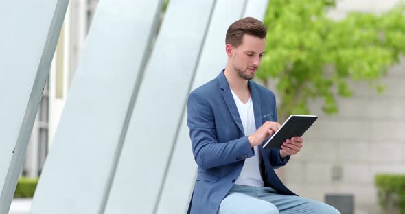 Businessman work on tablet computer in the city