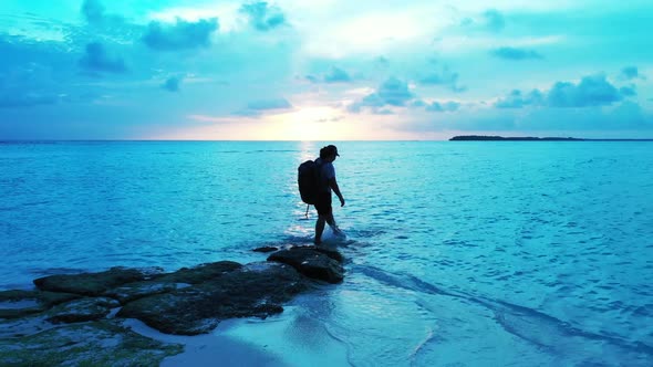 Tourist suntans on exotic island beach time by blue water with clean sandy background of the Maldive