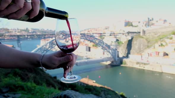 Slow Motion of a Red Wine Pouring From the Bottle to the Glass