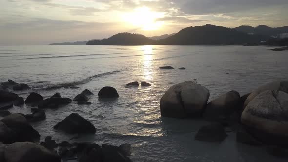 Rock and sea during sunset hour.