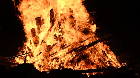 Big Bonfire Burns at Night in Slow Motion on a Black Background on Nature