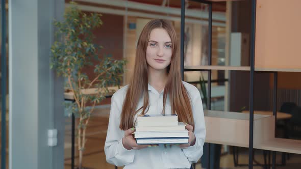 Portrait of a Schoolboy of the Senior Classes with Books in Hands in a School Class