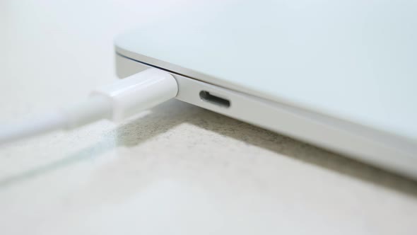 Closeup of Pulling Laptop By the White Usbc Cable Connected to the Laptop