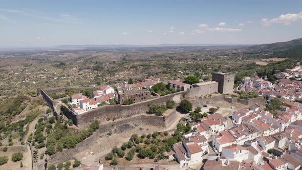 Quaint medieval hilltop Castle, Castelo de Vide, Portugal. Aerial establishing shot