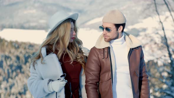 Stylish Couple Walking on Top of the Mountain