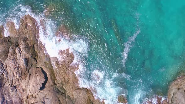 Aerial view Drone camera top down of seashore rocks in ocean Beautiful sea surface Amazing sea waves
