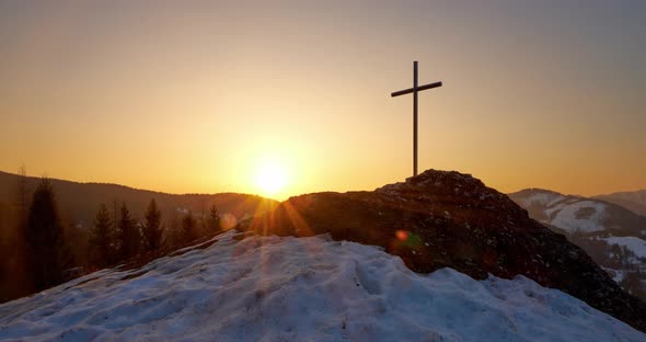 Christian Cross on a Snowy Rock at Sunrise Clear Sky Golden Hour Timelapse