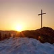 Christian Cross on a Snowy Rock at Sunrise Clear Sky Golden Hour Timelapse - VideoHive Item for Sale