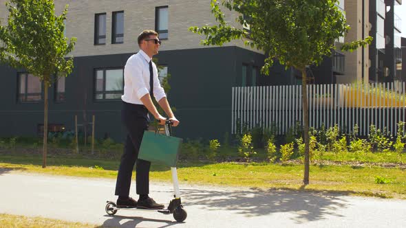 Businessman with Shopping Bag Riding Scooter