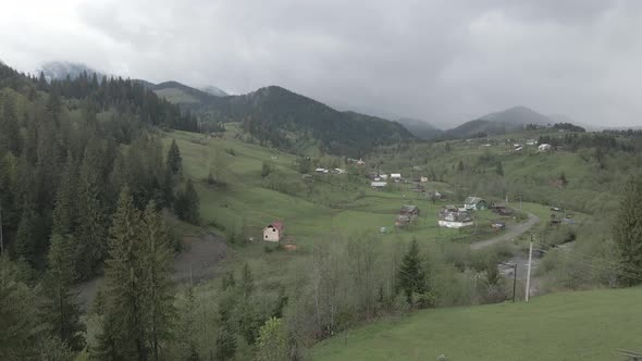 Ukraine, Carpathian Mountains: Village in the Mountains. Aerial, Flat, Gray