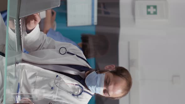 Vertical Video Health Specialist Using Laptop Computer to Plan Appointments